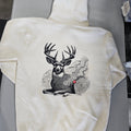 White sweatshirt with a black and white deer graphic on a gray surface