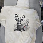 White sweatshirt with a black and white deer graphic on a gray surface